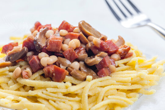 spatzles with bacon, beans and mushroom sauce
