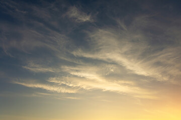 Background of cirrus clouds on the burning dawn in the sky after golden sunset.