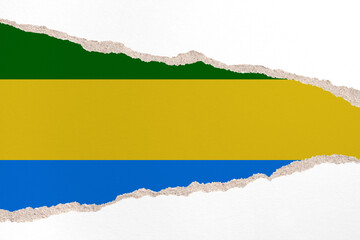 Ripped paper background in colors of national flag. Gabon