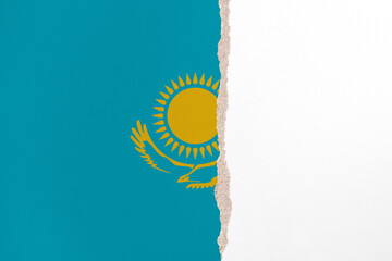 Half- ripped paper background in colors of national flag. Kazakhstan