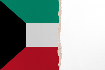 Half- ripped paper background in colors of national flag. Kuwait