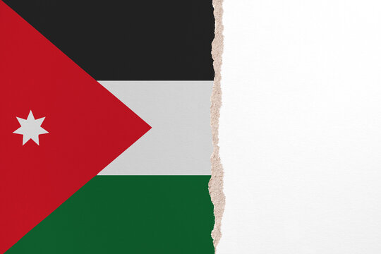 Half- ripped paper background in colors of national flag. Jordan
