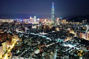 Fotobehang Aerial panorama over Taipei after dark, the capital city of Taiwan, with Taipei 101 Tower among skyscrapers in Xinyi Financial District, crowded buildings in downtown & city lights at night © AaronPlayStation