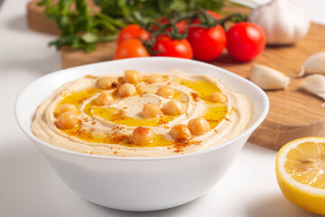 Delicious hummus with chickpeas, olive oil, lemon and pita bread. Vegetarian food concept.