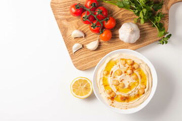 Delicious hummus with chickpeas, olive oil, lemon and pita bread. Vegetarian food concept.