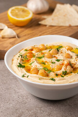Delicious hummus with chickpeas, olive oil, lemon and pita bread. Vegetarian food concept.