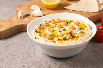 Delicious hummus with chickpeas, olive oil, lemon and pita bread. Vegetarian food concept.