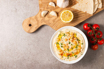 Delicious hummus with chickpeas, olive oil, lemon and pita bread. Vegetarian food concept.