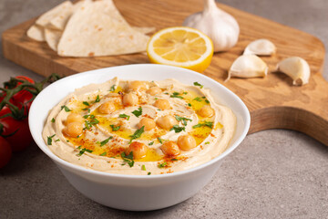 Delicious hummus with chickpeas, olive oil, lemon and pita bread. Vegetarian food concept.