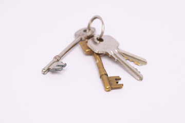 Closeup of a stack of keys isolated on a white background with copyspace