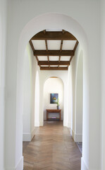 Arched hallway with wooden beam ceiling