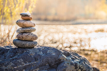 Balancing stone on shore. Balance of scales. Harmony in decision making Balanced stones on top of boulder. Peace of mind balance for meditation.