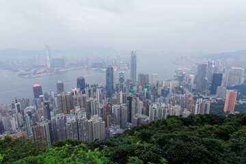 Scenery of Hong Kong viewed from top of Victoria Peak in hazy dusk with city skyline of crowded skyscrapers by the harbour and Kowloon, with air pollution level classified as "Beyond Index" (PM 2.5 )