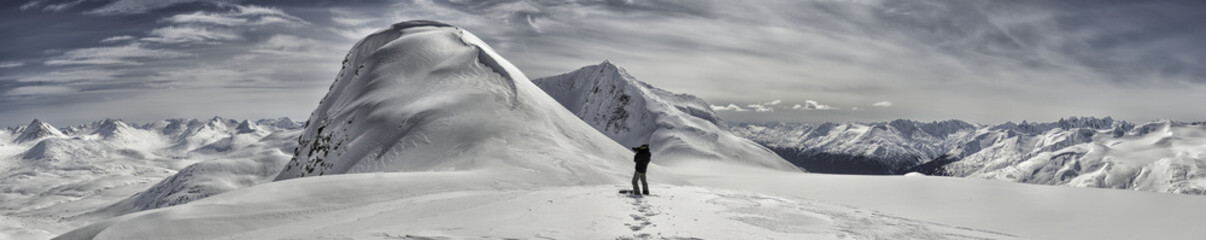 Photographer overlooking Coast Mountains between White Pass and Chilkot Pass in winter