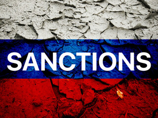 Flag of Russia on the cracked dry ground with Sanctions word, international sanction against Russia concept