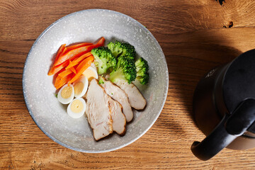 fresh transparent soup diet broth with chicken egg and broccoli, top view. chicken broth

