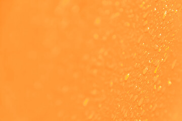 Yellow smooth surface with drops of water as textural background