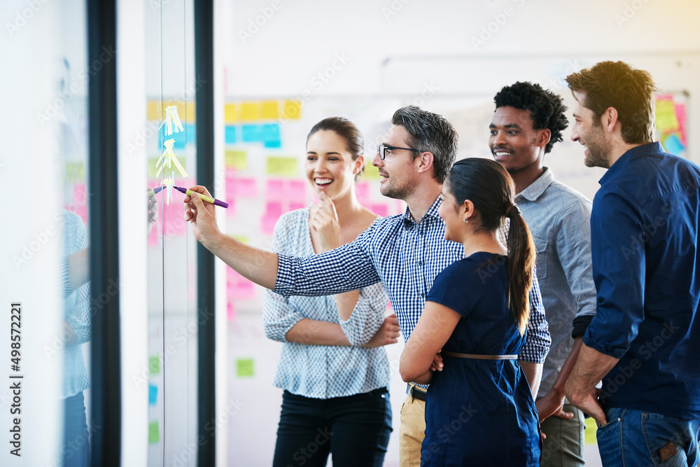 Poster time for a strategy meeting. shot of a group of colleagues having a meeting in the boardroom.