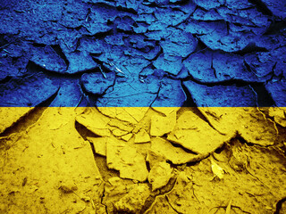 Flag of Ukraine on the cracked dry ground