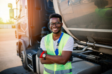 Portrait of handsome young African American man working in towing service on the road. Roadside assistance concept.