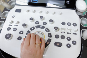 Obstetrician Pushes Buttons on a Control Panel Before Starting Ultrasound Sonogram Procedure.