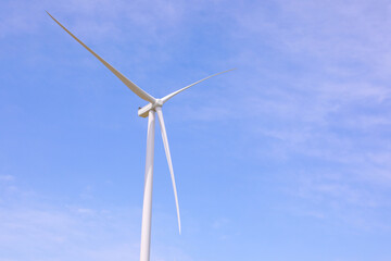 Wind turbines against the backdrop of a sunny sky. Green ecological energy generation. Eco field wind farm