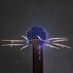 Fireworks exploding near the Reunion Tower in Dallas, Texas at New Year