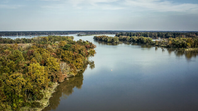 Aerial drone shot of Lake Houston surrounded by colorful trees in Kingwood, Texas, United States