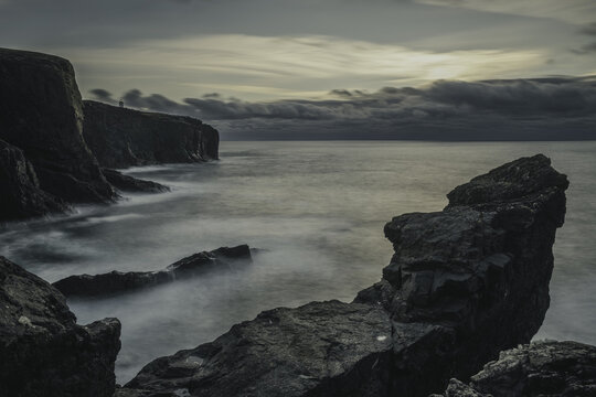 Eshaness cliffs in Shetland, Scotland with the Eshaness lighthouse in the background