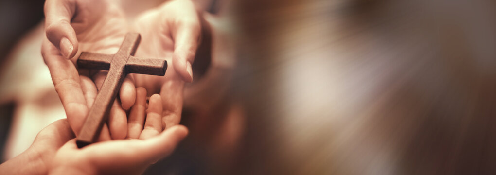 Woman's hand with cross .Concept of hope, faith, christianity, religion, church online.