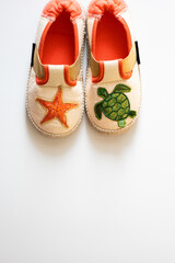 Children's house slippers on a white background. High quality photo