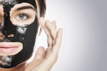 Woman with deep cleansing black mask on her face
