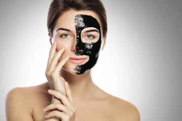 Woman with deep cleansing black mask on her face