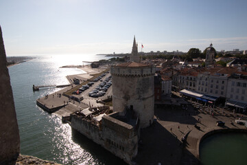 View of La Rochelle tower from stony viewpoint under shining sun