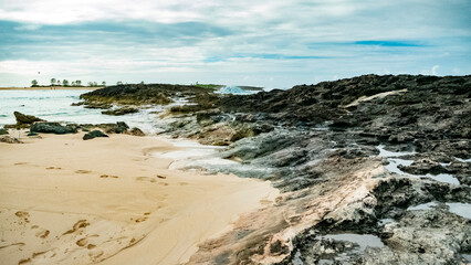 clouds black rocks shore