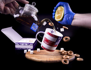 Fototapeta na wymiar USA and European Union political symbols on a cup of tea with lemon as symbol of Ukraine