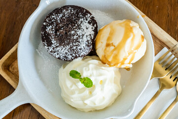 Chocolate Lava Cake with Vanilla syrup, ice-cream and whip cream Taken with selected spot focus area. Concept of cafe and restaurant.