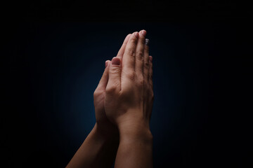 Fototapeta premium hands prayer over dark background, concept of faith and religion