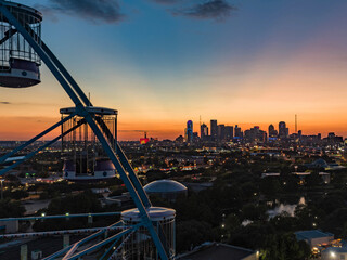 Scenic skyline with skyscrapers during sunset shot of a ferris wheel in Dallas, Texas