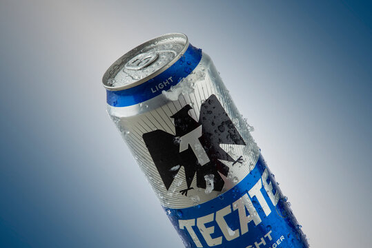 Mexico ,CDMX - April 12, 2022: Tecate light in can with ice and blue background