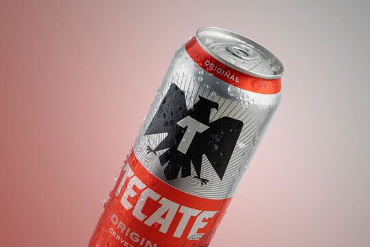 Mexico ,CDMX - April 12, 2022: Tecate Roja in can with ice and red background