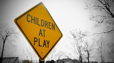 Closeup shot of a yellow children at play sign in a park