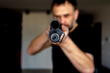 man holding a hunting rifle with a sight. Sight close up