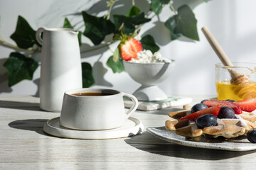 Light breakfast toast with strawberries and blueberries kiwi with coffee 