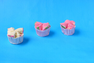 Steamed sponge cake, or bolu kukus food from Indonesia. isolated on a blue background - obrazy, fototapety, plakaty