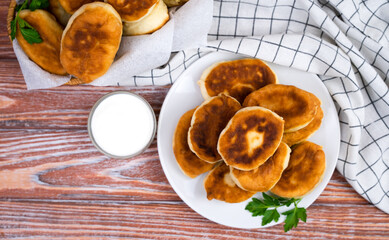 Homemade fried pies with meat and potatoes on a wooden table. Top view. Close-up. Copy space.