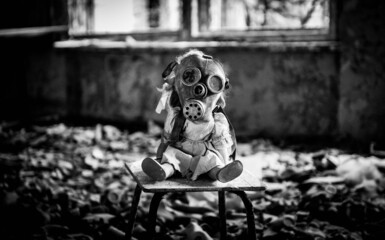 Grayscale shot of a creepy doll with a respiratory gas mask in an abandoned building