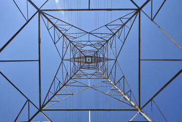 Transmission tower view from below looking straight up against the blue sky in Ontario, Canada