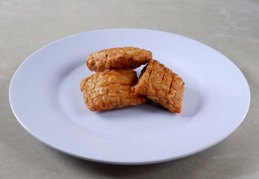 Closeup shot of a Indonesian traditional fried tempe garit on a white plate