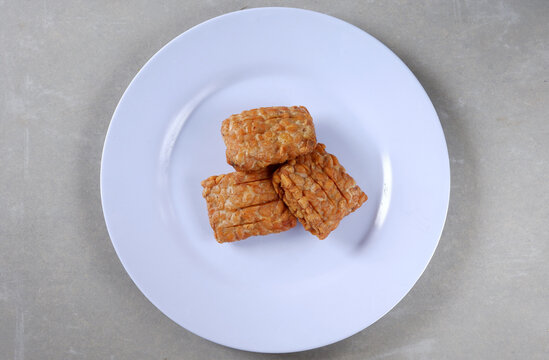 Closeup shot of a Indonesian traditional fried tempe garit on a white plate